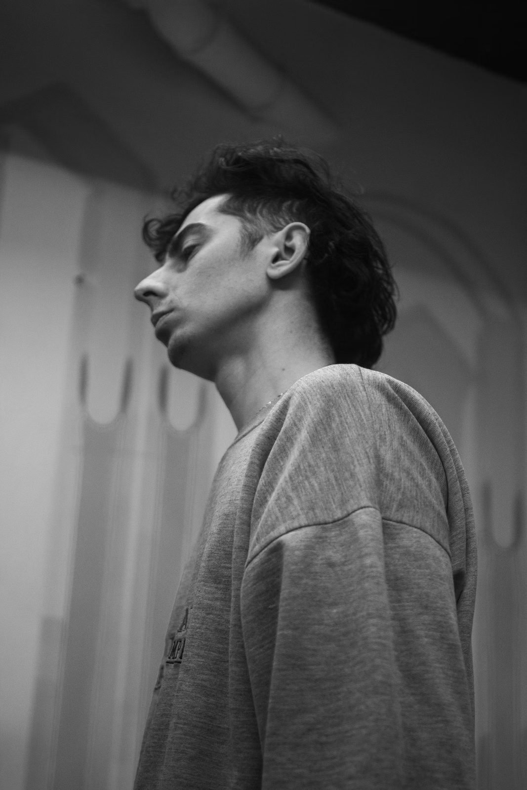 Retrato en blanco y negro de Lionel E. Festa de perfil, en una sala escénica.